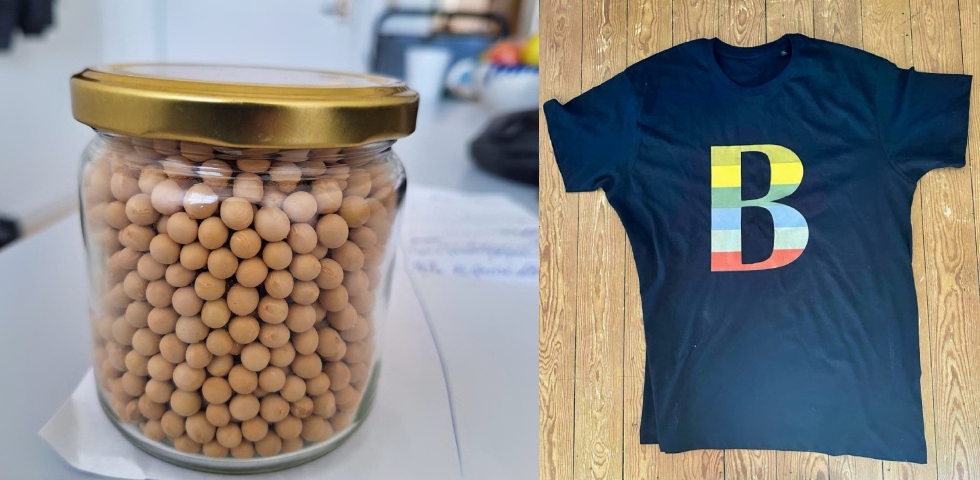 En burk med kikärtor och bredvit en svart tshirt med färgglad logga i form av ett B