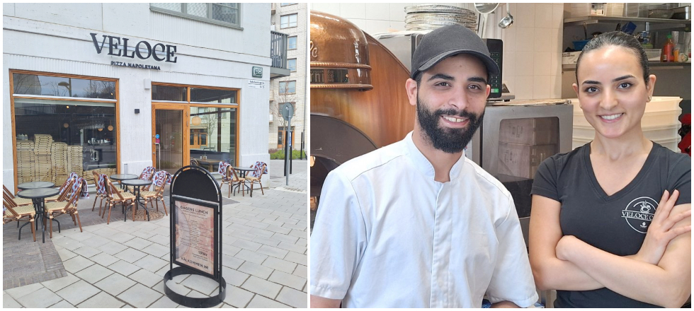 Till vänster en vit hörnfasad med stora fönster och cakestolar utanför. Till vänster en man i keps, vit kockskjorta och svart skägg och en kvinna i svart tshirt med brunt hår uppsatt.